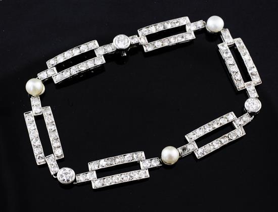 An early 20th century French white gold, cultured pearl and diamond set bracelet, 7.25in.